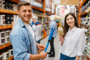 Young couple buying repair tools in hardware store