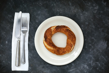 Simit turkish bagel isolated on black background.