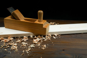 carpenter's background with copy space. planer with wood shavings on a wooden surface.