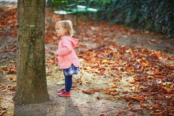 Adorable cheerful toddler girl in Tuileries garden in Paris, France