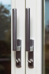Close up view of steel door handles on glass doors isolated. Interior design concept. 