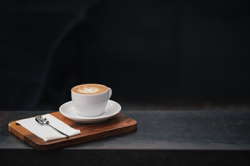 cup of coffee on wooden table, vintage color
