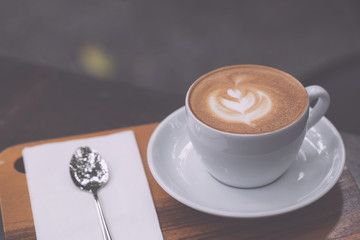 cup of coffee on wooden table, vintage color