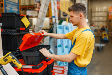 Constructor choosing toolbox in hardware store