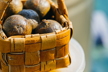 bee propolis balls in little wooden basket on local market, bee products