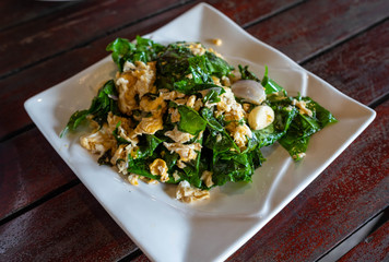Stir-Fried Baegu Leaves with Eggs in white plate.Baegu Leaves , plant in southern of Thailand.