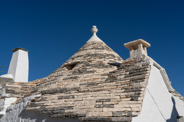 Fototapeta na wymiar Trulli of Alberobello. View of Trulli houses .The traditional Trulli houses in Alberobello city, Puglia, Italy - April 30, 2019: Church in Trullo Parish Sant'Antonio of Padua - Immagine