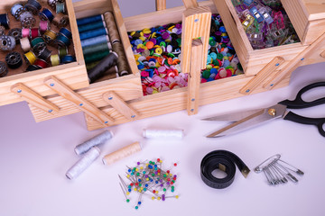 sewing box with sewing kit, scissors, thread, measuring tape and press studs