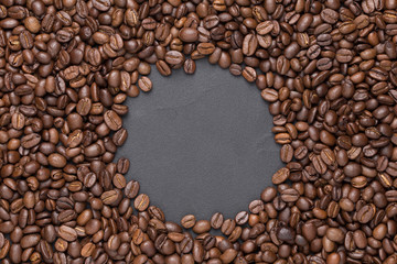 Roasted coffee beans round frame background on black with copy space