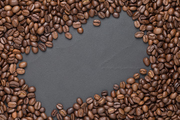 Roasted coffee beans frame background on black with copy space