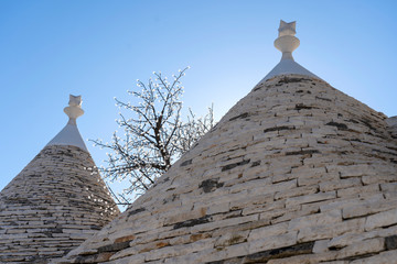 Fototapeta na wymiar Trulli of Alberobello. View of Trulli houses .The traditional Trulli houses in Alberobello city, Puglia, Italy - April 30, 2019: Church in Trullo Parish Sant'Antonio of Padua - Immagine
