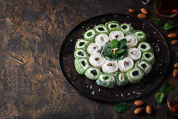 Turkish Delight. Assorted oriental sweets with nuts on a dark background.