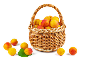 Fresh apricots in wicker baskets isolated on white background