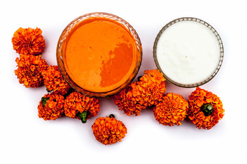Marigold flower and milk cream face mask for dry skin a glass bowl isolated on white with marigold...