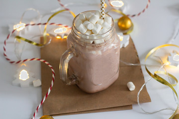 hot chocolate and christmas decorations on white background