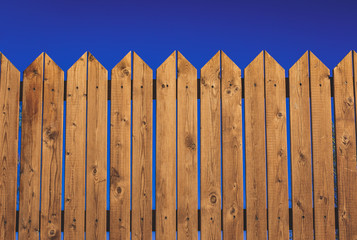 wooden deck wall garden fence textured simple background on vivid blue sky space 