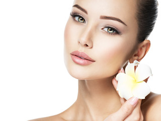 Beautiful face of young woman with flower