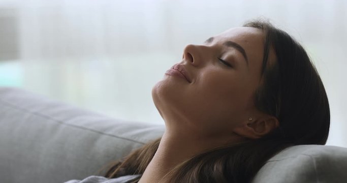 Healthy young woman taking deep breath of fresh air