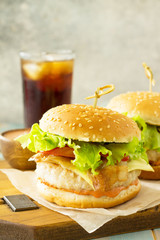 American snack Street food. Fast food. Homemade hamburger with bacon and cola drink on wooden rustic table. Free space for your text.