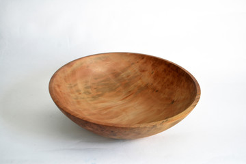 Empty wooden bowl on a light background 