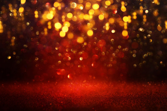 background of abstract red and gold glitter lights. defocused