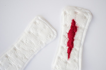  sanitary pad with red sparkles on a white background. Menstruation concept