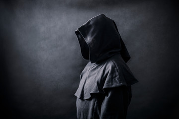 Scary figure in hooded cloak 