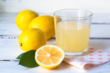fresh squeezed lemon juice in a simple glass isolated on white background