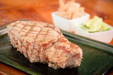 Grilled rib eye steak on a iron pan