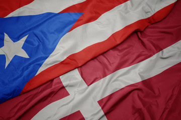 waving colorful flag of denmark and national flag of puerto rico.
