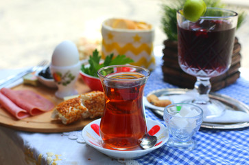 Turkish traditional black tea in the transparent glass cup on the table in Istanbul Turkey. Perfect breakfast.