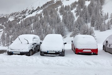 Parking cars covered with snow