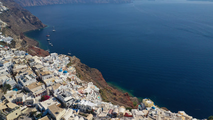 Aerial drone photo of traditional and picturesque village of Oia in volcanic island of Santorini, Cyclades, Greece