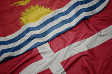 waving colorful flag of denmark and national flag of Kiribati .