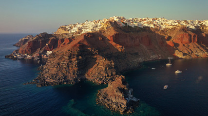 Fototapeta na wymiar Aerial panoramic photo of iconic and famous for sunset village of Oia, Santorini island at sunset, Cyclades, Greece
