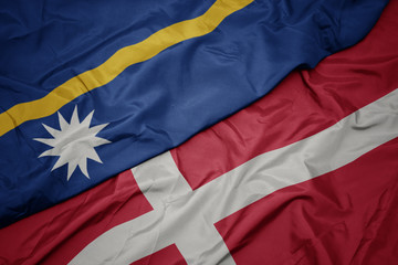 waving colorful flag of denmark and national flag of Nauru .