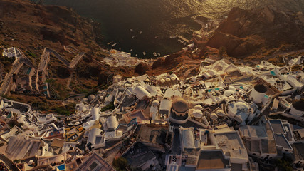Aerial drone photo of world famous beautiful sunset at traditional and picturesque village of Oia...