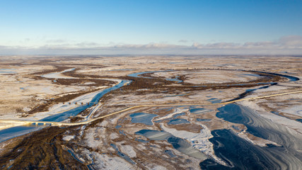 Winter Landscape of the forest-tundra, river bank, bird's eye view.Arctic Circle, tundra. Beautiful landscape of tundra from a helicopter.