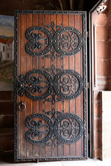 Detail of a wooden and wrought iron door of church in France