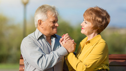Adult lovers met in the park. Man and woman aged a first date.