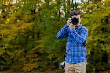 Professional photographer in action with two cameras on a shoulder straps