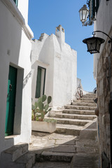Fototapeta na wymiar OSTUNI, ITALY - April 30, 2019: touristic trip. Travel view of Ostuni featuring some white houses part of the center of the village, historical center. The image location is Apulia in Italy, Europe.