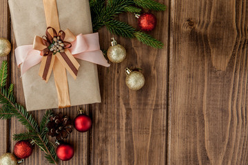 Christmas gift box, decor and fir tree branch on wooden table. Top view with copy space