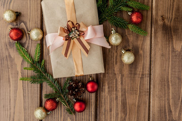 Christmas gift box, decor and fir tree branch on wooden table. Top view with copy space