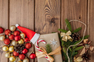 Christmas gift box, food decor and fir tree branch on wooden table. Top view with copy space