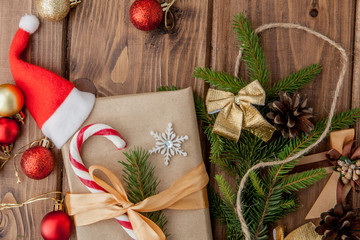 Christmas gift box, food decor and fir tree branch on wooden table. Top view with copy space