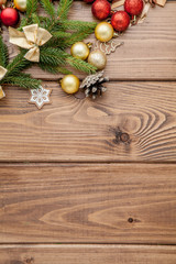 Christmas background with New year toys and fir tree branch on wooden table