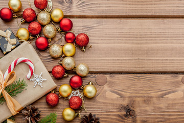 Christmas gift box, food decor and fir tree branch on wooden table. Top view with copy space