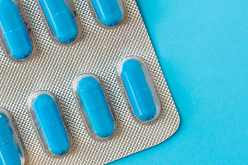 Medications, pills, thermometer, traditional medicine for treating colds, flu, heat on a blue background. Maintenance of immunity. Seasonal diseases. Top view. Medicine flat lay