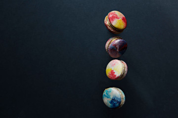 colorful macaroons on dark background